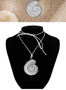 Detailed view of silver nautilus spiral shell pendant with adjustable white beach cord