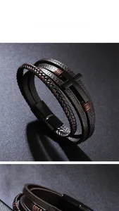 Detail view of multilayer leather bracelet with cross charm and magnetic clasp closure