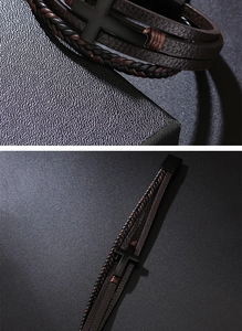 Macro detail of multilayer braided leather bracelet with matte black metal cross charm