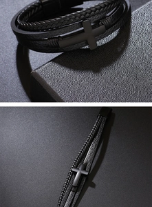 Detail view of multi-layer braided leather bracelet with matte black metal cross charm