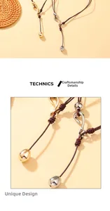 Detailed view of handmade brown leather cord knot with gold and silver metal pendant charms