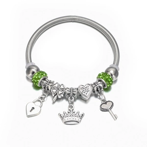 Detail of silver beaded bracelet with heart lock, clover, crown and key charms