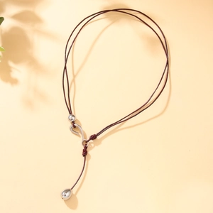 Minimalist Y-shaped necklace with brown leather cord and silver teardrop metal pendant