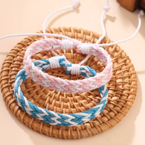 Braccialetti dell'amicizia intrecciati a mano regolabili in rosa e blu su vassoio