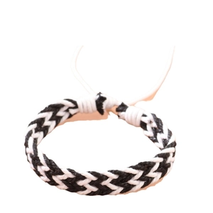 Handmade woven cord bracelet in black and white with adjustable drawstring closure