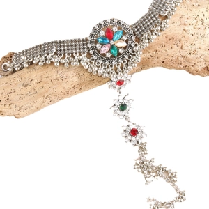 Ethnic bohemian silver bracelet with colorful gemstone flowers and hanging beads on wood