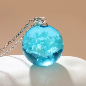 Luminous blue sky cloud resin ball pendant necklace with silver chain on stand