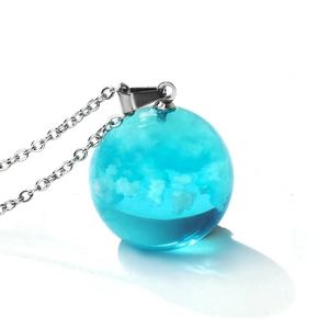 Luminous blue resin globe necklace featuring realistic clouds and silver chain