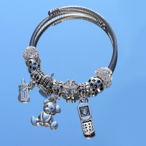 Silver bear and mobile phone charms on a twisted wire charm bracelet with crystals