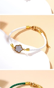 Detailed view of woven leather bracelet with a gold-framed four-leaf clover charm