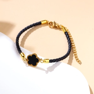 Elegant black woven leather bracelet with gold flower pendant and adjustable chain