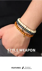 Close-up of three beaded stretch bracelets with metal cross charms on a male model