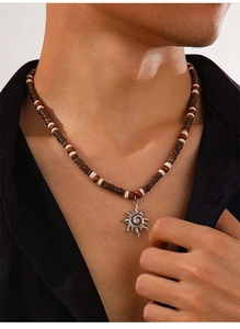 Detail of wooden bead necklace with silver sun flower pendant on male model