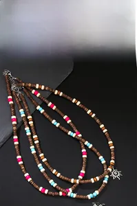 Detail of bohemian wood bead necklaces with silver sun pendants and lobster clasp