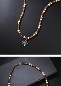 Detail of bohemian wood bead necklace with a silver sun pendant and lobster clasp