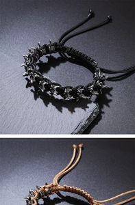Detail of gothic punk woven bracelet with vintage silver dragon bone metal accents
