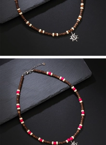 Detailed view of bohemian wood bead necklaces featuring a silver sun charm and lobster clasp