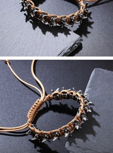 Detail of adjustable gothic punk bracelet showing metal bone charms and woven cord