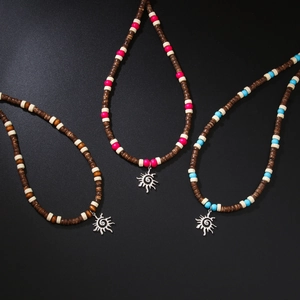 Bohemian beaded surfing necklaces with wooden beads and silver sun pendants on black base
