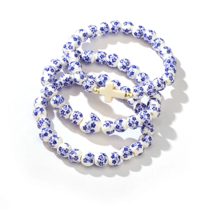 Three-piece ceramic bead bracelet set with blue floral pattern and cross charm