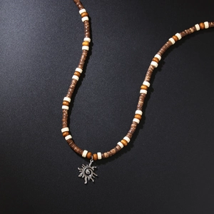 Bohemian men's wood bead necklace with sunburst pendant on dark textured background