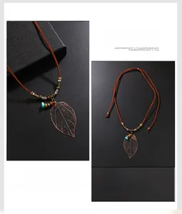 Détail d'un pendentif feuille ajourée bohème rétro avec perles colorées et cordon