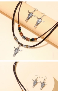 Close-up of retro silver bull head pendant with wooden beads on double layered necklace