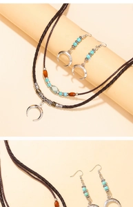 Close-up of bohemian jewelry set with turquoise beads and silver crescent pendants