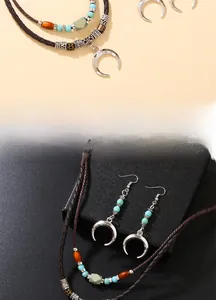 Detail view of ethnic beaded necklace with crescent moon pendant and turquoise accents