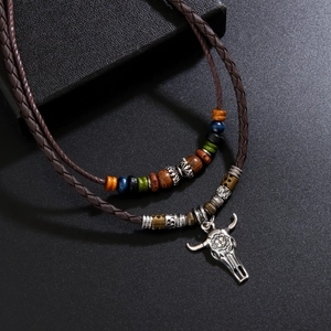 Retro bull head pendant necklace with colorful wood beads on a braided leather cord