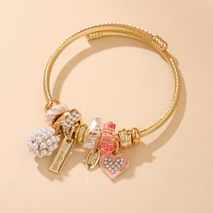 Handmade gold twisted bangle with pink heart charm and white pearl cluster accents
