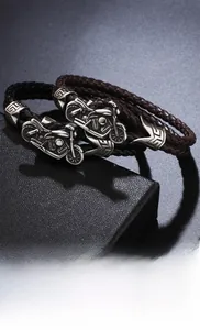 Detail of men's punk woven leather bracelets with intricate alloy motorcycle charms