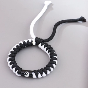 Handmade woven Yin Yang bracelet with black and white cords and adjustable drawstring