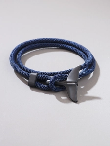 Close-up of nautical dark blue braided rope bracelet with matte black whale tail clasp