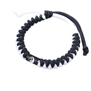 Handwoven black and white rope bracelet featuring a Tai Chi Yin Yang symbol charm