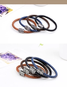 Close-up of four-piece men's braided leather bracelets featuring antique scorpion charms
