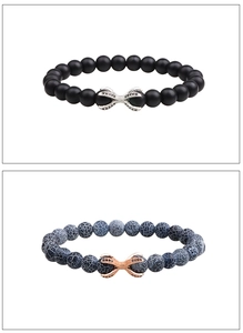 Detail of matte black and blue dragon agate beaded bracelets with micro zircon claw charms