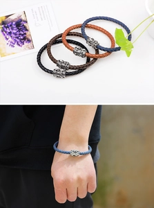 Handwoven leather bracelet with antique silver metal charm detail in four colors