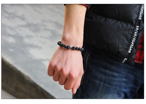 Detail of matte black beaded bracelet featuring vintage silver claw accents on wrist