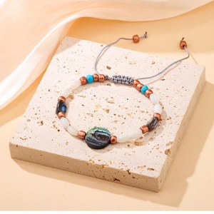 Bracelet ajustable fait main en nacre d'abalone avec turquoise sur fond de soie