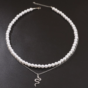 Double-layered hip hop necklace with white pearls and silver snake pendant on black background