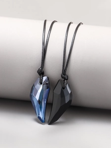 Detailed view of wolf tooth crystal necklaces with black woven cords for couples