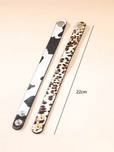 Detail of 22cm leopard and cow print faux leather bracelets with metal snap buttons
