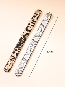 Detail view of 22cm leopard and snake print leather bracelets with metal button snaps