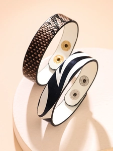 Detailed close-up of leopard and zebra print leather bracelets with metallic snap buckles