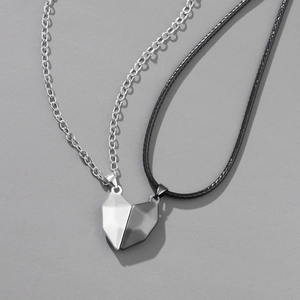 Magnetic heart couple necklaces set with geometric stitching pendants on grey background