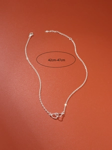 Close-up of interlocking silver hearts necklace showing adjustable 42cm-47cm chain length