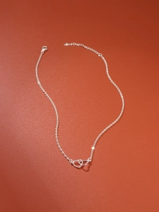 Detailed view of silver interlocking heart necklace with adjustable lobster clasp