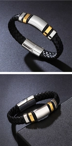 Detail of black braided leather men's bracelet with silver and gold metal magnetic clasp