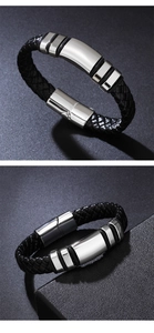 Detail of men's braided black leather bracelet with polished silver metal accents